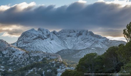 Schnee bedeckte Gipfel der Serra de Tramuntana unter dunklen Wolken
